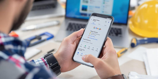 Contractor managing Google My Business on smartphone.